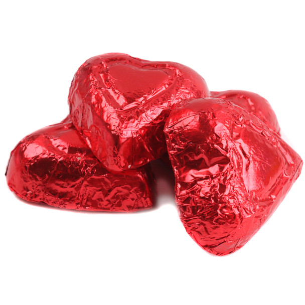 Bright red foil-wrapped mini milk chocolate hearts, approx. 55 per pound, ideal for Valentine's Day.