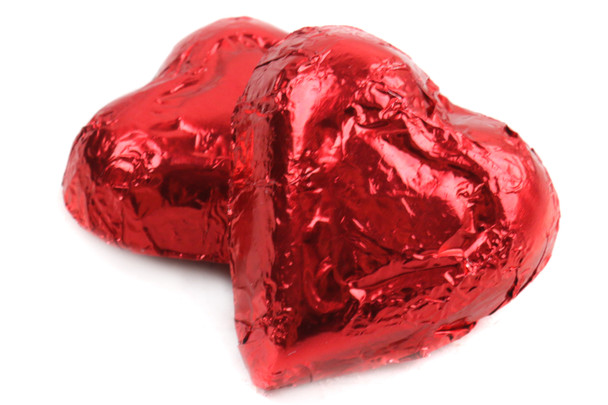 Bright red foil wrapped milk chocolate mini hearts, approx 55 per pound, ideal for Valentine's Day candy.