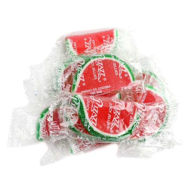 Watermelon jelly fruit slices, individually wrapped, bright pink centers, green, white edges, sugary coating.