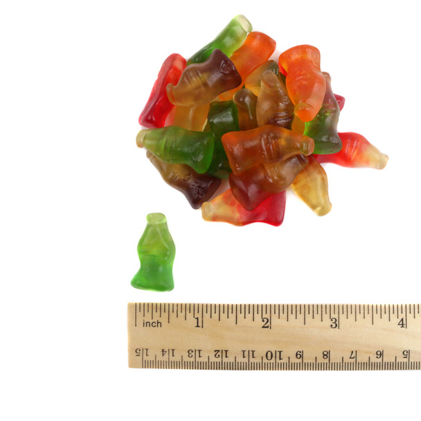 Colorful gummy soda pop bottles, orange, lemon-lime, cola, grape flavors, approx 1.5'' tall.