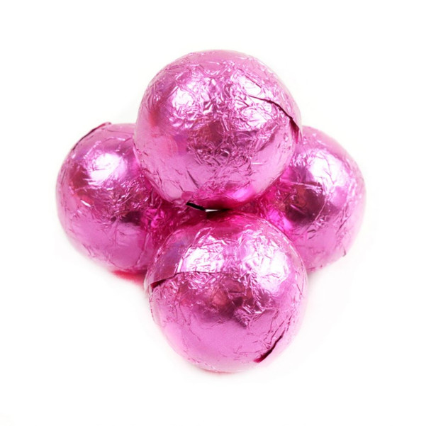 Pink foil-wrapped solid milk chocolate balls, 3/4 inch diameter, approximately 60 per pound.