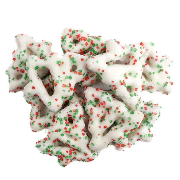 Christmas tree-shaped pretzels, white yogurt coated, sprinkled with festive red and green sugar for the holidays.