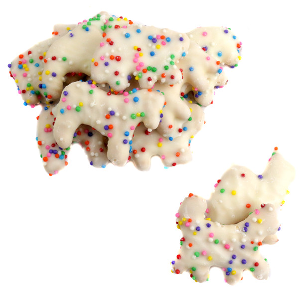 White yogurt covered animal crackers with colorful rainbow nonpareil candy beads.
