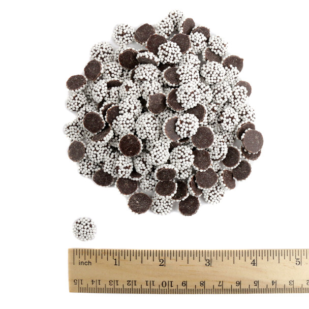 Mini dark chocolate nonpareils, bite-sized, topped with white sprinkles. Rich, smooth, crunchy candy treats.