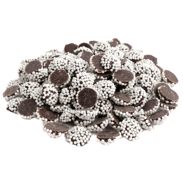 Many mini dark chocolate nonpareils, bite-sized, rich dark brown chocolate with white crunchy sprinkles, decadent candy.