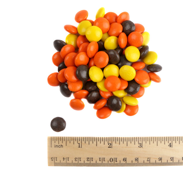 Reese's Pieces, small button-sized peanut butter candy in yellow, orange, brown colors, approx 500 pieces per pound.