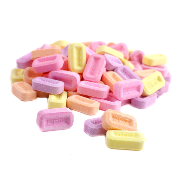 Bulk Pez assorted fruit pressed candies, colorful watermelon, blue raspberry, grape, orange, apple, cherry, pineapple.