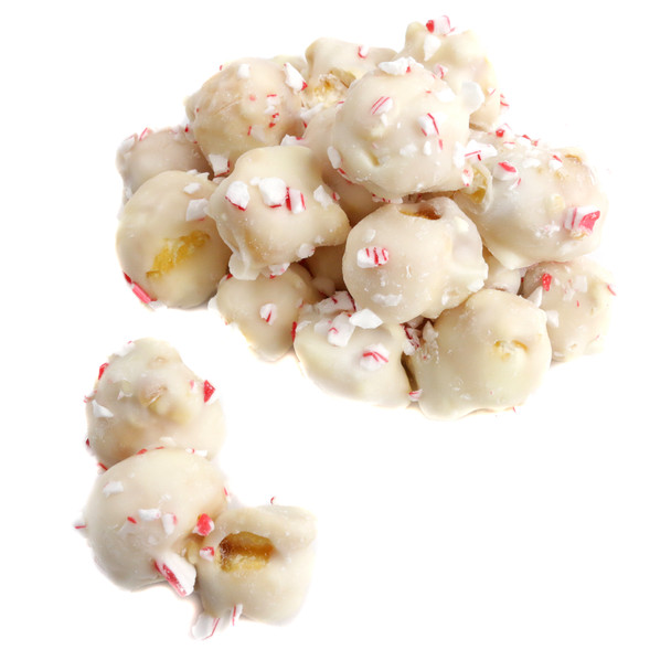 Festive white popcorn generously sprinkled with vibrant red crushed candy cane pieces, delicious peppermint flavor.
