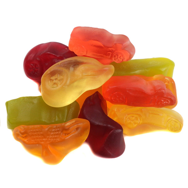 Approx. 90 colorful Hot Wheels Gummies, assorted racecar, vehicle, logo shapes, orange, red, green, yellow.