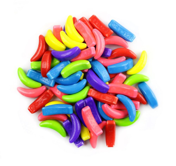 Bright, rainbow-colored, banana-shaped Crazy Bananas Pressed Candy, 680 pieces per pound, delicious banana flavor.