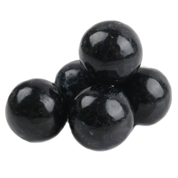 Numerous striking black tutti frutti gumballs, uniform single color, round candy.