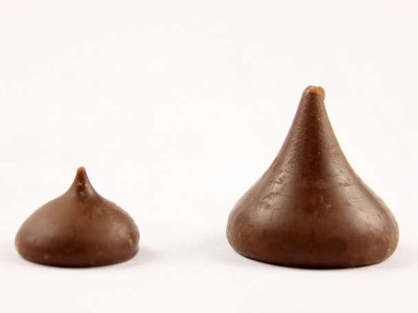 25lb bulk box of unwrapped Mini Hershey Kisses, small brown chocolate candies, approx. 230 per pound.