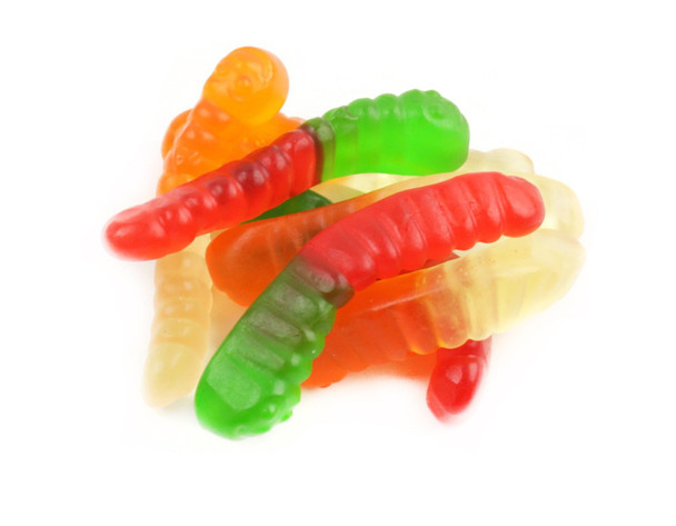 Bulk case of Albanese Mini Gummy Worms. Many small, colorful red, orange, yellow, green, blue, purple, pink fruit flavors.