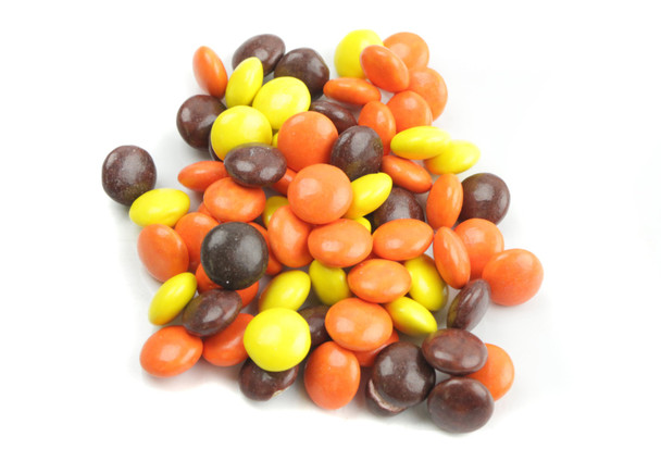 Reese's Pieces 25lb bulk. Smooth peanut butter buttons in yellow, orange, and brown candy shells.