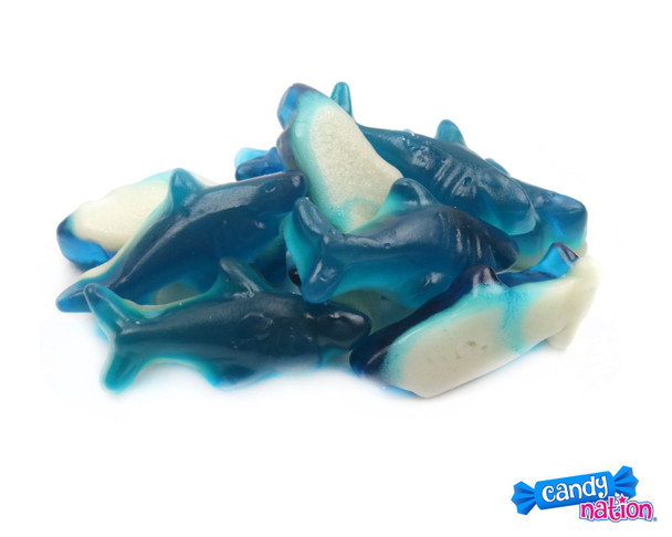 Vibrant blue gummy sharks with white marshmallowy foam, blue raspberry flavor. 6 count, 5LB bulk candy.