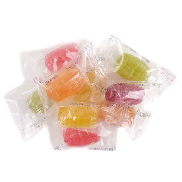 A bulk pile of colorful, individually wrapped Roses Brands Natural Assorted Flavor Barrel hard candies in clear twist-wrappers