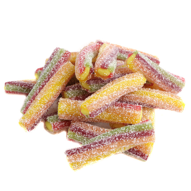 A pile of Fini Sour Rainbow Twister licorice bites sliced to show the sweet white cream filling inside the sour, multi-colored candy straw exterior