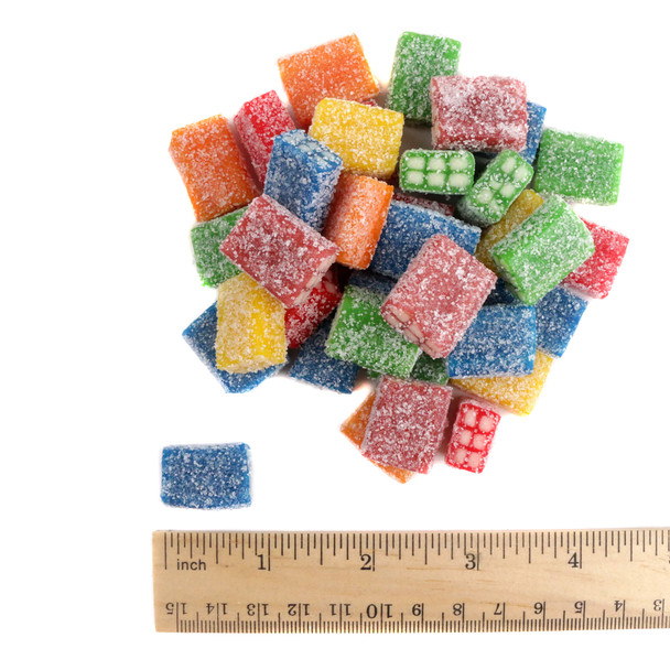 Fini Extra Sour Licorice Bricks showing their size and vibrant red, blue, orange, yellow, and green sour candy shells