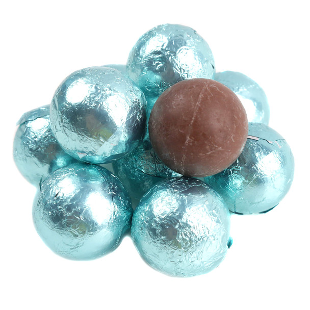 a robin's egg blue foil-wrapped chocolate ball alongside an unwrapped solid milk chocolate sphere