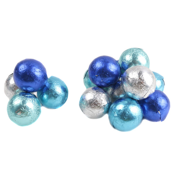An assortment of round milk chocolate candy tightly wrapped in blueand silver foil resting on a white background