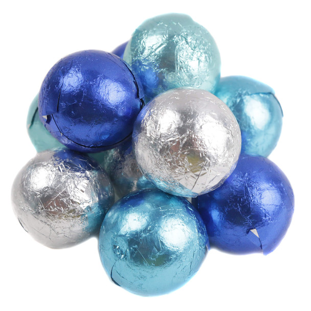 A bulk pile of spherical milk chocolate candies individually wrapped in shiny blues and silver metallic foil