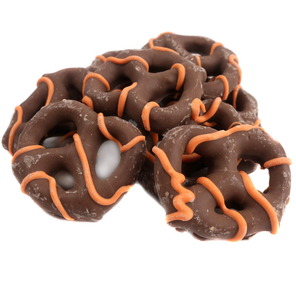 Chocolate-covered pretzels with orange drizzle decorated for Halloween.