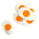 Giant gummy fried eggs, white and yellow, 35 peach flavored candies, approximately 3 inches each.