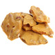 Crispy, nutty brown peanut brittle in various shapes, featuring roasted peanuts. Old-fashioned sweet and salty candy.