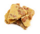 Crispy, nutty brown peanut brittle in various shapes, featuring roasted peanuts. Old-fashioned sweet and salty candy.