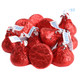 Red Hershey Kisses, iconic bite-sized milk chocolate candy, wrapped in shiny red foil. Approximately 100 per pound.