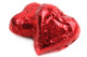 Bright red foil wrapped milk chocolate mini hearts, approx 55 per pound, ideal for Valentine's Day candy.