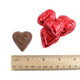 Red mini milk chocolate hearts, individually foil-wrapped in bright red, approx. 55 per pound. Perfect Valentine's Day candy.