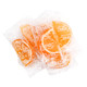 Vibrant orange jelly fruit slices, sugar-drenched, individually wrapped in clear cellophane, approx 32 slices per pound.