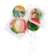 A vibrant display of wrapped and unwrapped Tiger Pops lollipops, highlighting their signature colorful red, yellow, and green stripes.