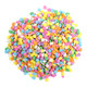 Colorful pastel confetti sprinkles, sequin shaped, for Easter baking, cupcakes, cakes, and desserts.