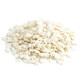 A close-up pile of white snowflake-shaped candy sprinkles featuring intricate cut winter snowflake designs