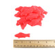 Many bright red sour gummy fish candies with a white sugar coating.