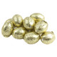 Pile of golden, shiny foil wrapped milk chocolate flavored eggs, about 80 pieces per pound, bulk Easter candy.