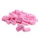 Many pink Pez Strawberry candy pieces, bulk unwrapped.