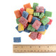 Fini Extra Sour Licorice Bricks showing their size and vibrant red, blue, orange, yellow, and green sour candy shells