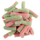 A bulk display of Fini Sour Strawberry Apple Licorice Twists showing the vibrant, dual-colored red and green chewy candy straws