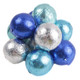 A bulk pile of spherical milk chocolate candies individually wrapped in shiny blues and silver metallic foil