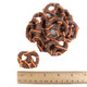 Chocolate-dipped pretzels featuring orange Halloween-themed drizzle.