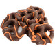 Chocolate-covered pretzels with orange drizzle decorated for Halloween.