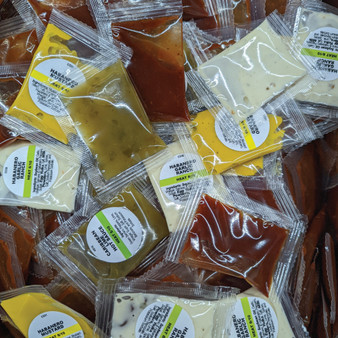 Image showcasing a diverse assortment of individual serving-sized Packets, highlighting the numerous sauce options available, offering versatility in flavors and choices.