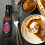 Image showcasing the Habanero Pumpkin Hot Sauce bottle with the Danny Cash Brand applied to the bottle and showcasing the sauce alongside a plate of Pumpkin Pie. Image showcasing the Habanero Pumpkin Hot Sauce bottle with the Danny Cash Brand applied to the bottle and showcasing the sauce alongside a plate of Pumpkin Pie.