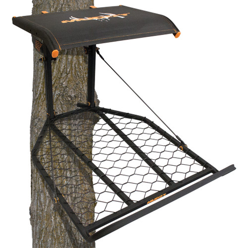 Muddy Outdoors Muddy Boss XL Hang On Stand, black hunting stand with safety rail and mesh seat, attached to a tree for hunting or wildlife observation.