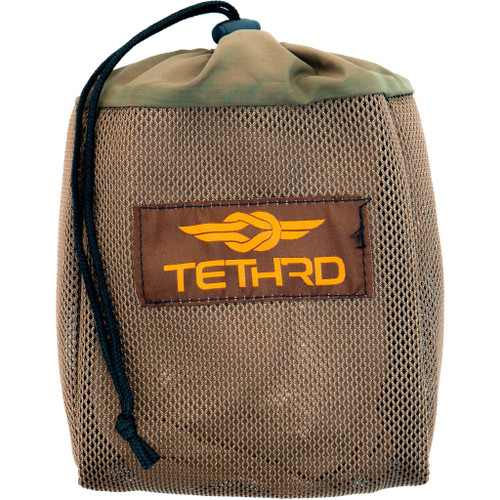 Tethrd Sys Hauler Coyote, a durable camo-colored mesh carrying bag with a black drawstring and Tethrd logo embroidered on the front.