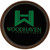 Woodhaven Legend Turkey Call Glass, round wooden turkey call with green logo and black background.