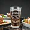 Personalized pint glass with laser etched whiskey label design. Perfect for milestone birthday gifts, shown with food in the background. Ideal for celebrating vintage themed birthdays.